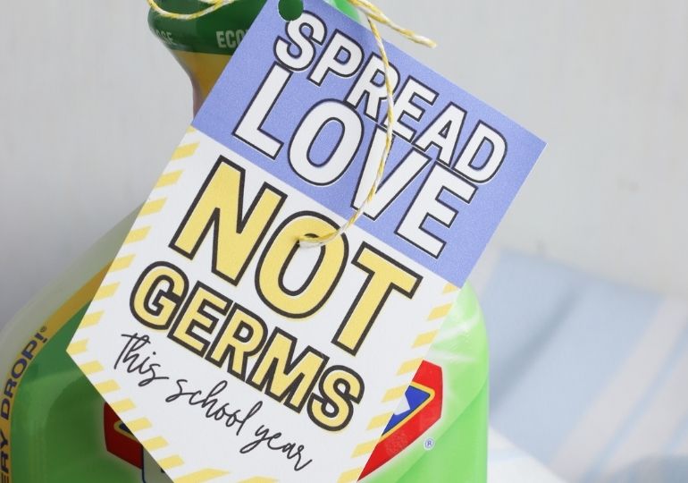 cleaner with a gift tag that says spread love not germs