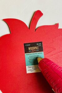 putting hot glue on apple wooden cutout