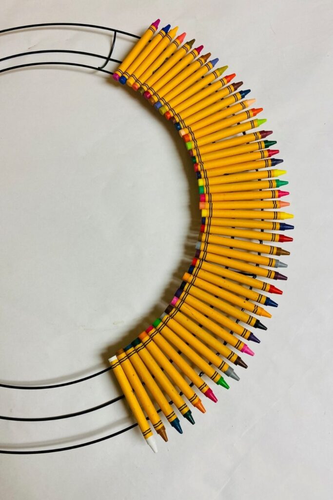 crayons glued on a metal wreath frame 