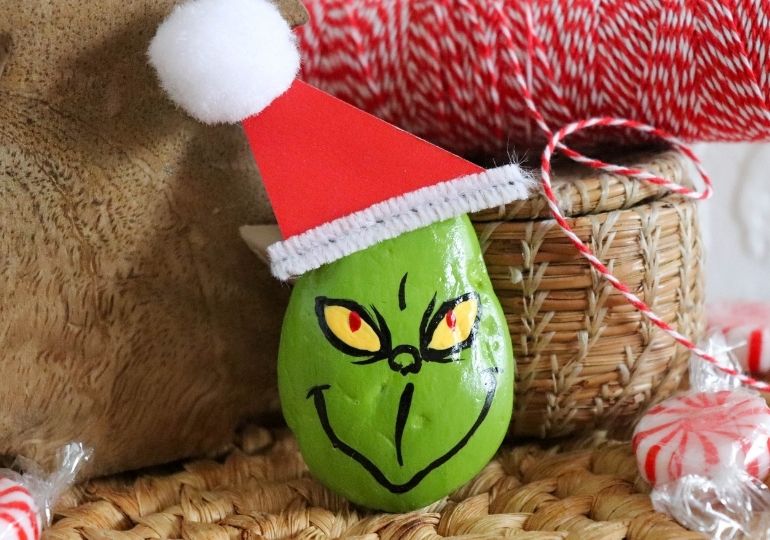 Grinch painted rock on counter