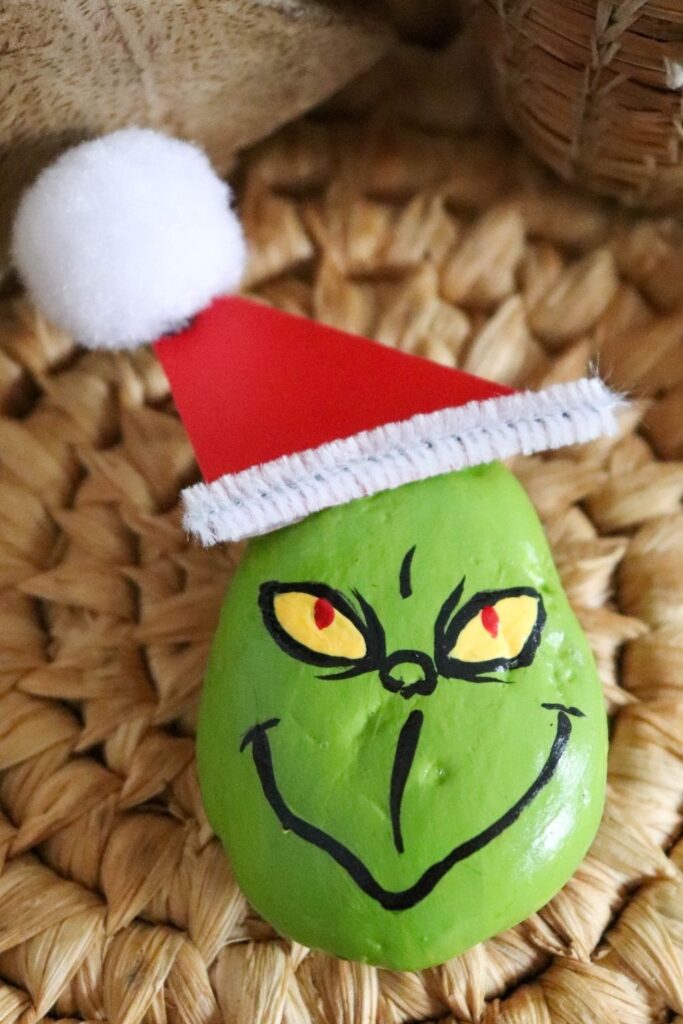 painted rock diy of a grinch on woven 