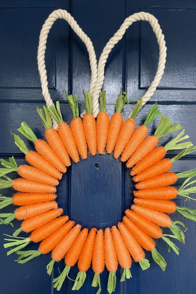 bunny carrot wreath hanging on a blue door