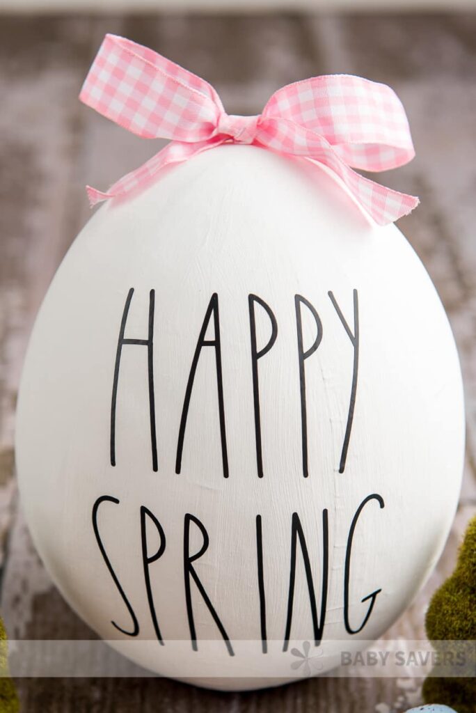 rae dunn designed faux easter egg on wooden counter 