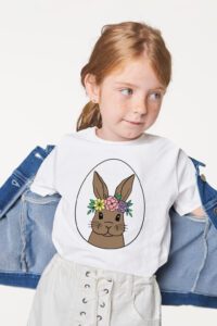 girl wearing easter shirt with denim jacket on