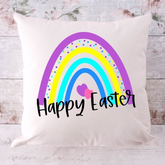 rainbow easter pillow on wooden background 